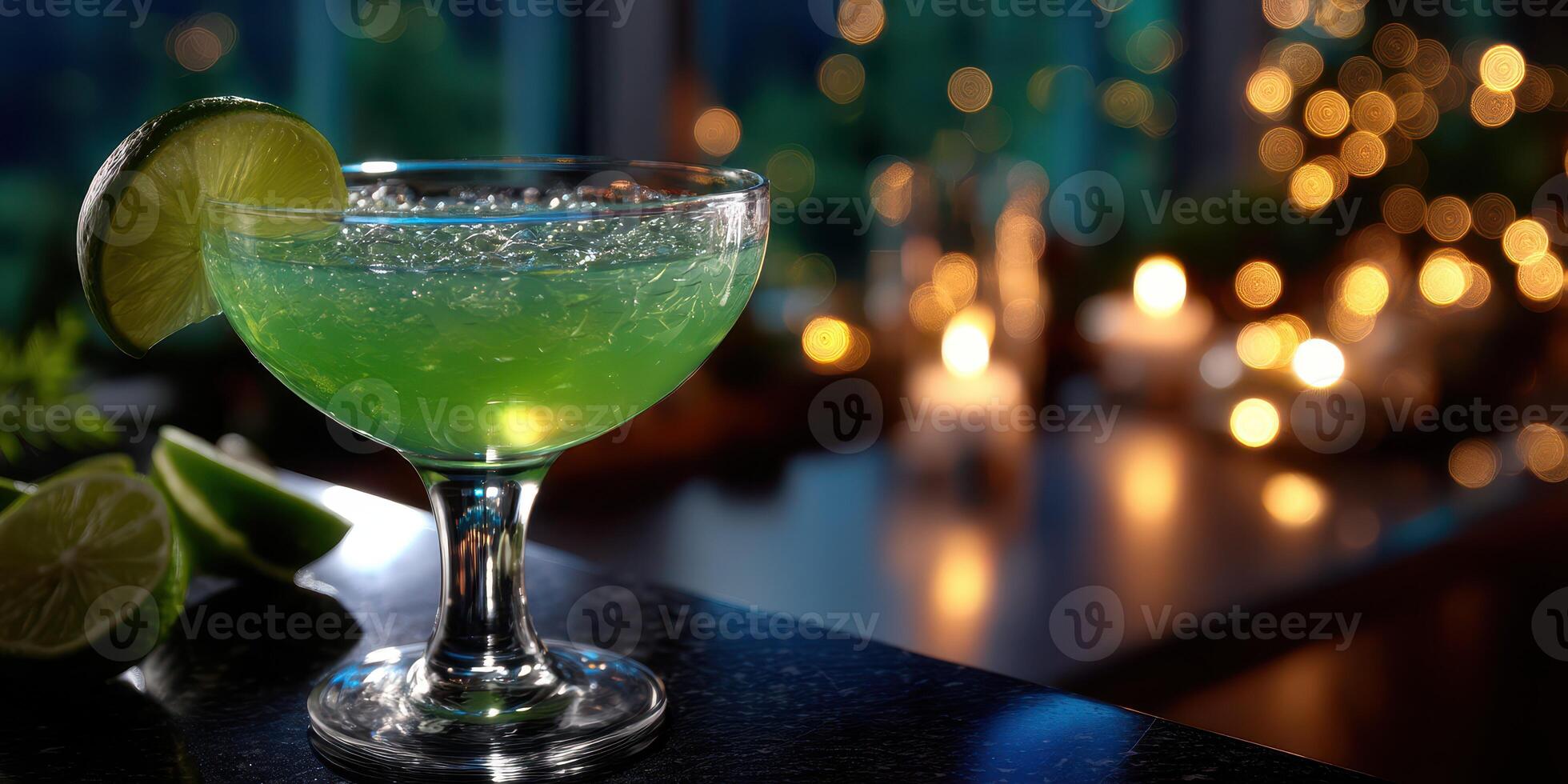 Refreshing green cocktail with lime slice on a bar counter during an evening gathering photo