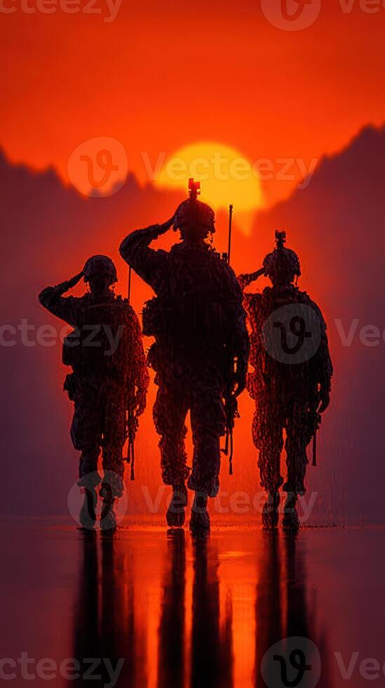 Soldiers saluting at sunset against a vibrant orange sky in a mountainous landscape photo
