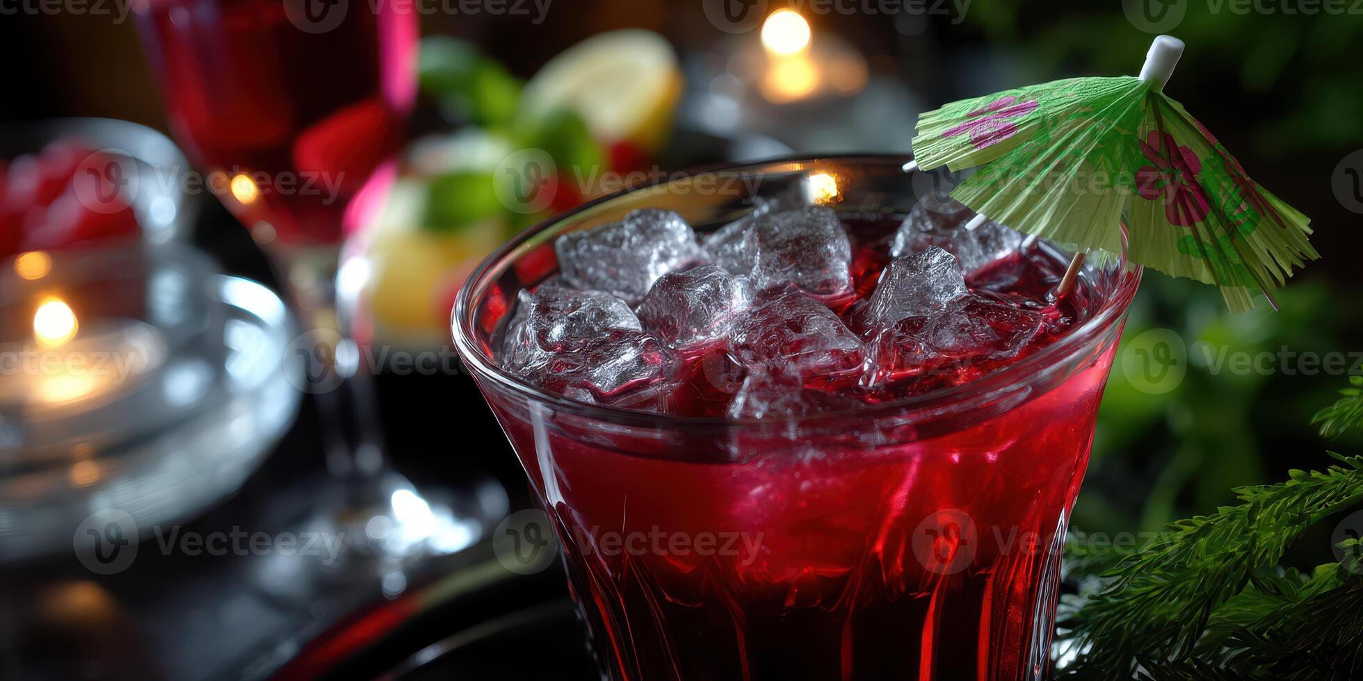 Refreshing cocktail with ice and colorful garnish served in a dimly lit setting photo