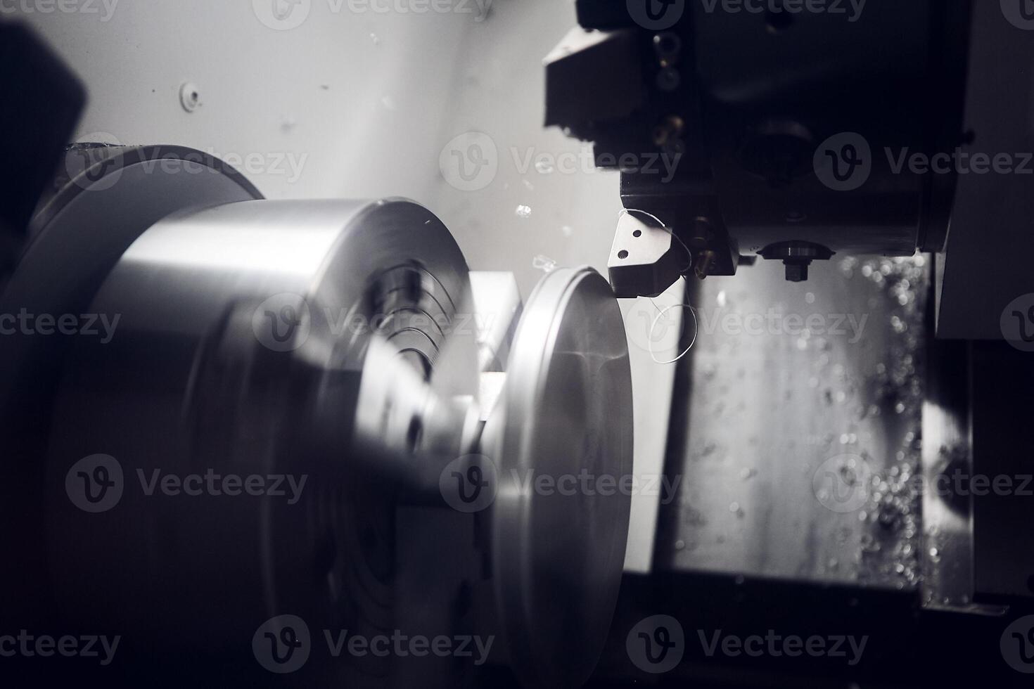 CNC lathe machine cutting metal shaft parts. The hi-technology metal working processing by CNC turning machine. photo