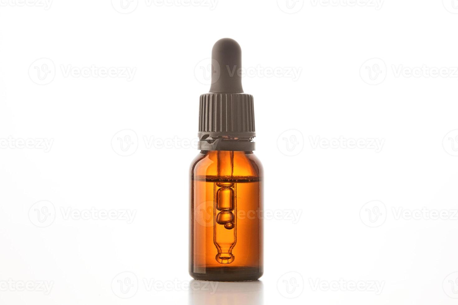 Brown glass container with pipette for cosmetic product. photo