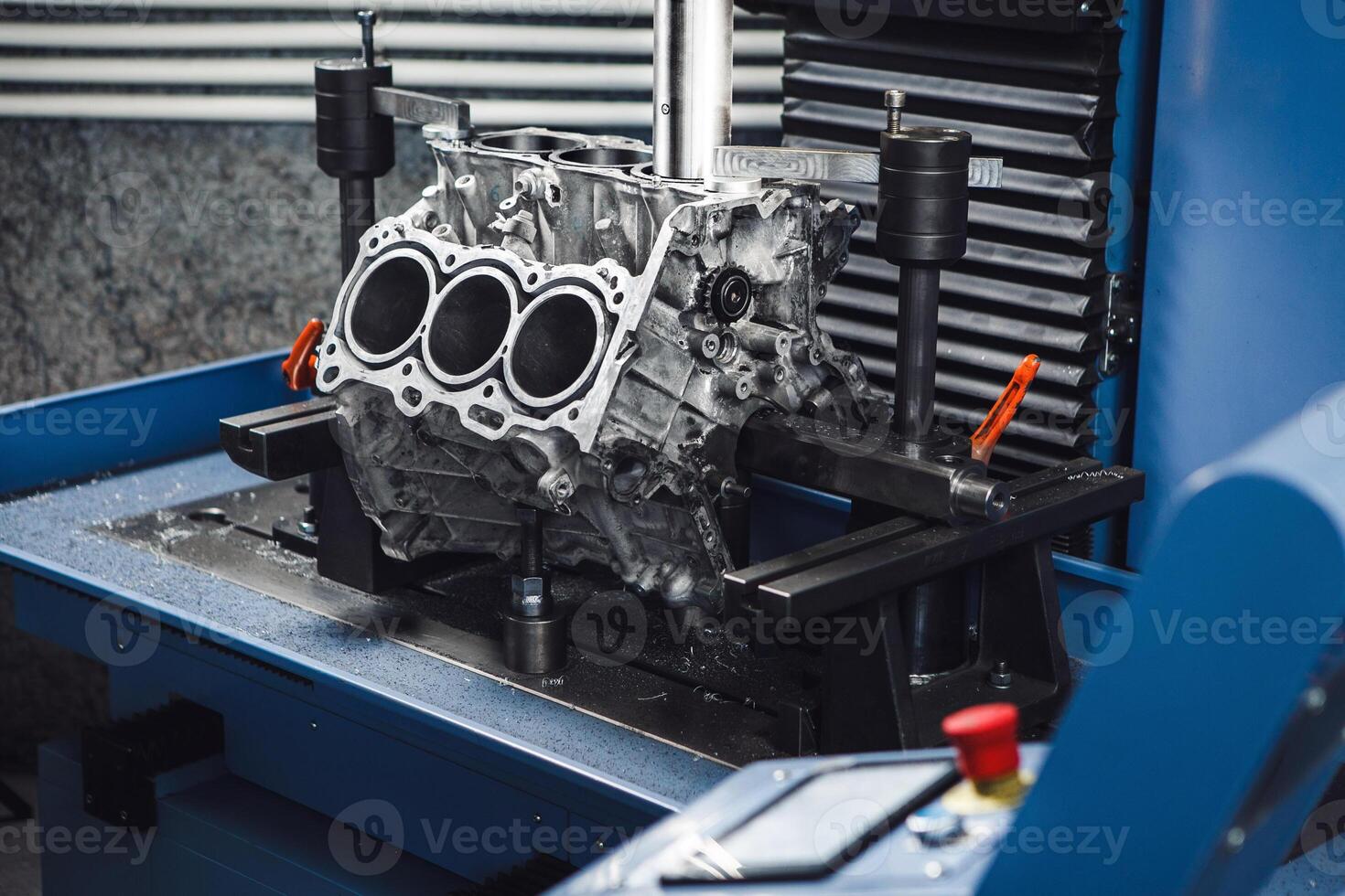 Three-cylinder engine repair on CNC machine, boring under the piston using machine with Computer Numerical Control. photo