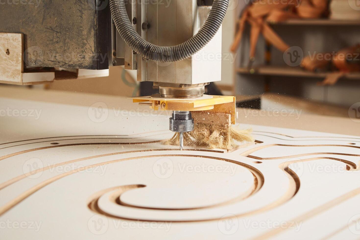 Numerically controlled woodworking machine cuts rounded complex lines on the canvas. Computer numerical control. CNC. photo