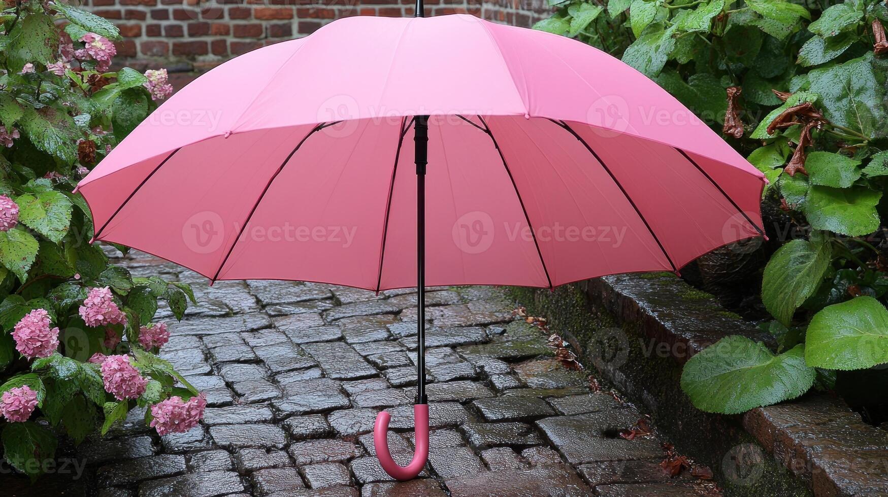 A pink umbrella is open in the rain photo