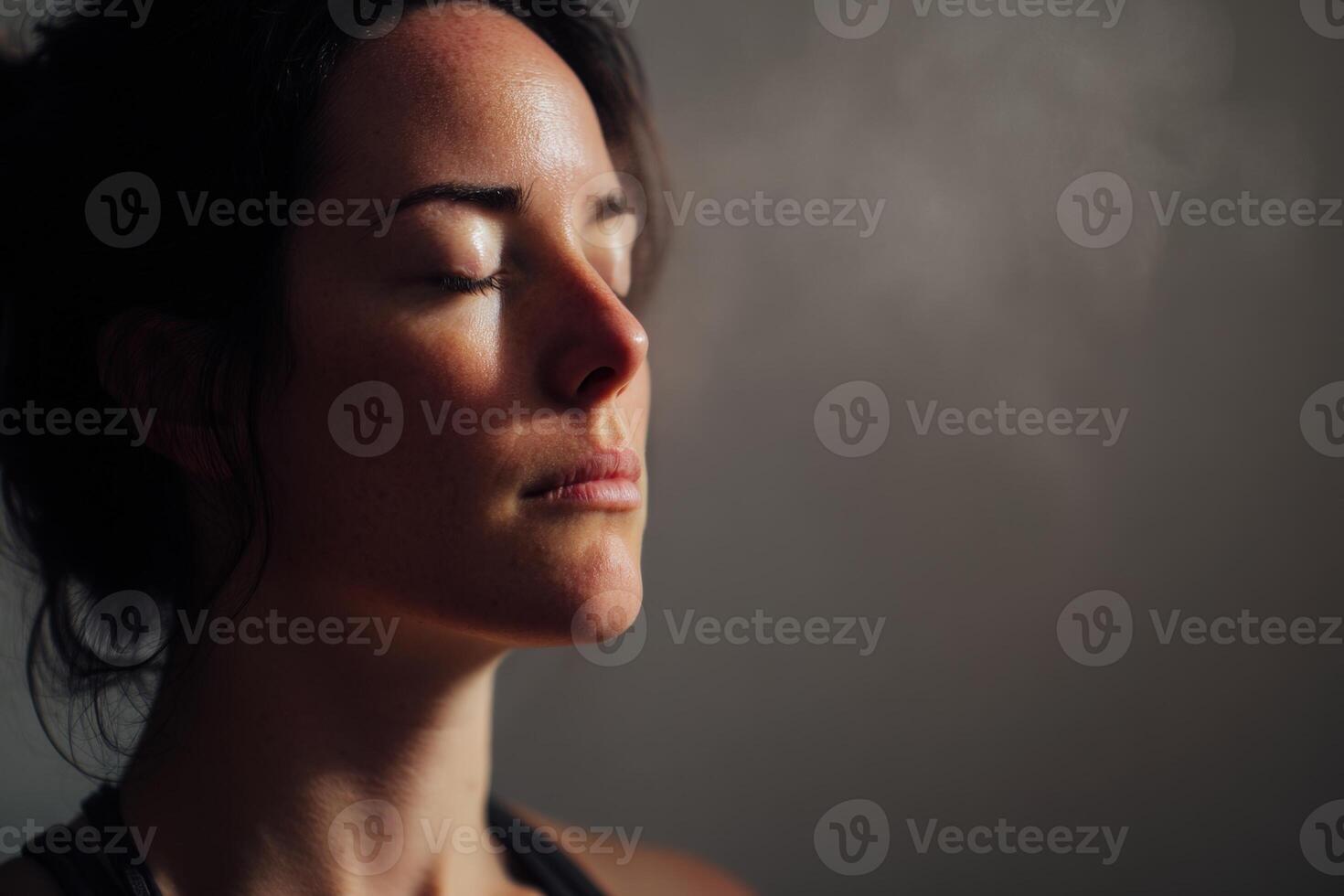 Calm woman with closed eyes, dark hair, and soft natural light on her face, creating a peaceful and serene atmosphere her expression is composed, reflecting meditation or relaxation photo