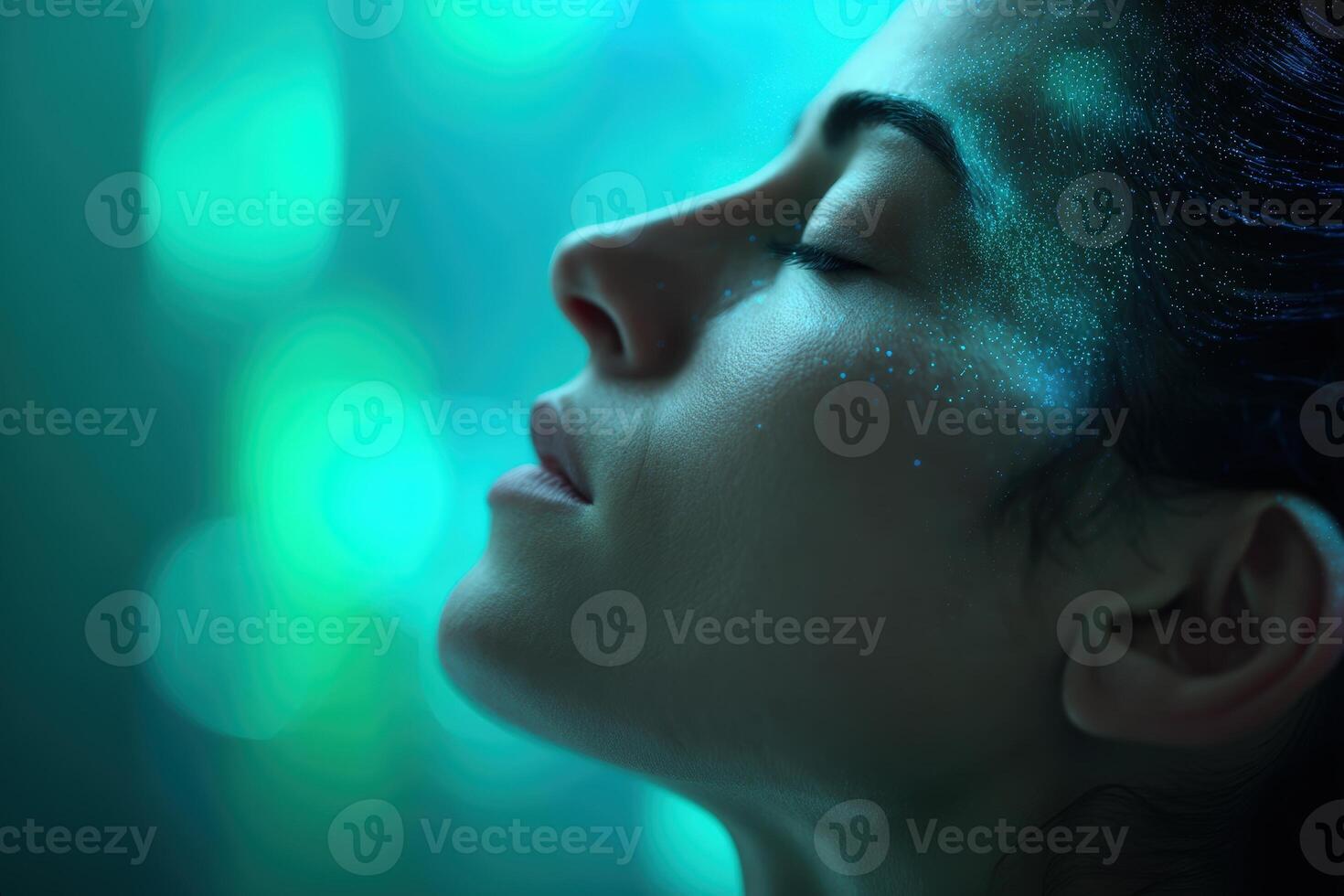 Serene close-up of a woman with closed eyes, illuminated by soft blue-green light, highlighting her calm expression and skin texture. Dreamy atmosphere with gentle focus on features photo