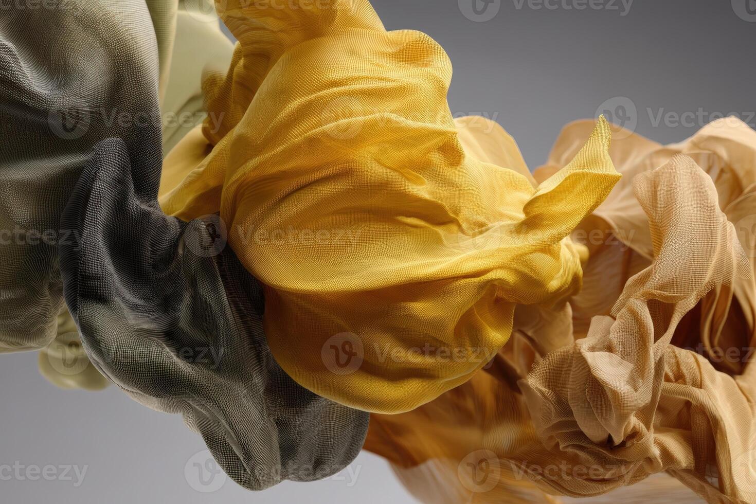 Abstract arrangement of flowing, delicate fabrics in muted tones including gray, mustard yellow, and soft beige, creating a sense of movement and fluidity in an artistic composition photo