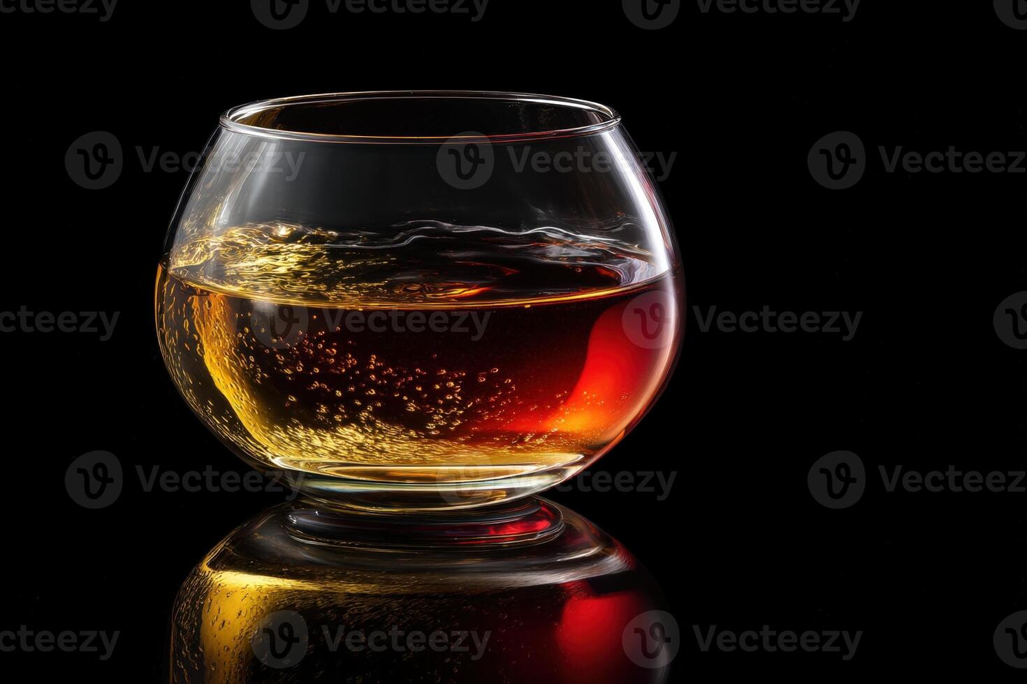 A rounded glass filled with amber liquid, displaying bubbles and subtle reflections. The drink's rich color contrasts with the dark background, creating an elegant and sophisticated scene photo