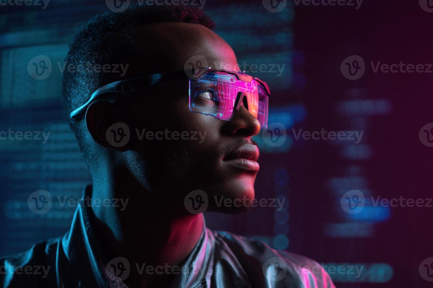 A man wearing futuristic transparent glasses with pink and blue highlights gazes thoughtfully. Background features blurred code, creating a modern, technological atmosphere photo