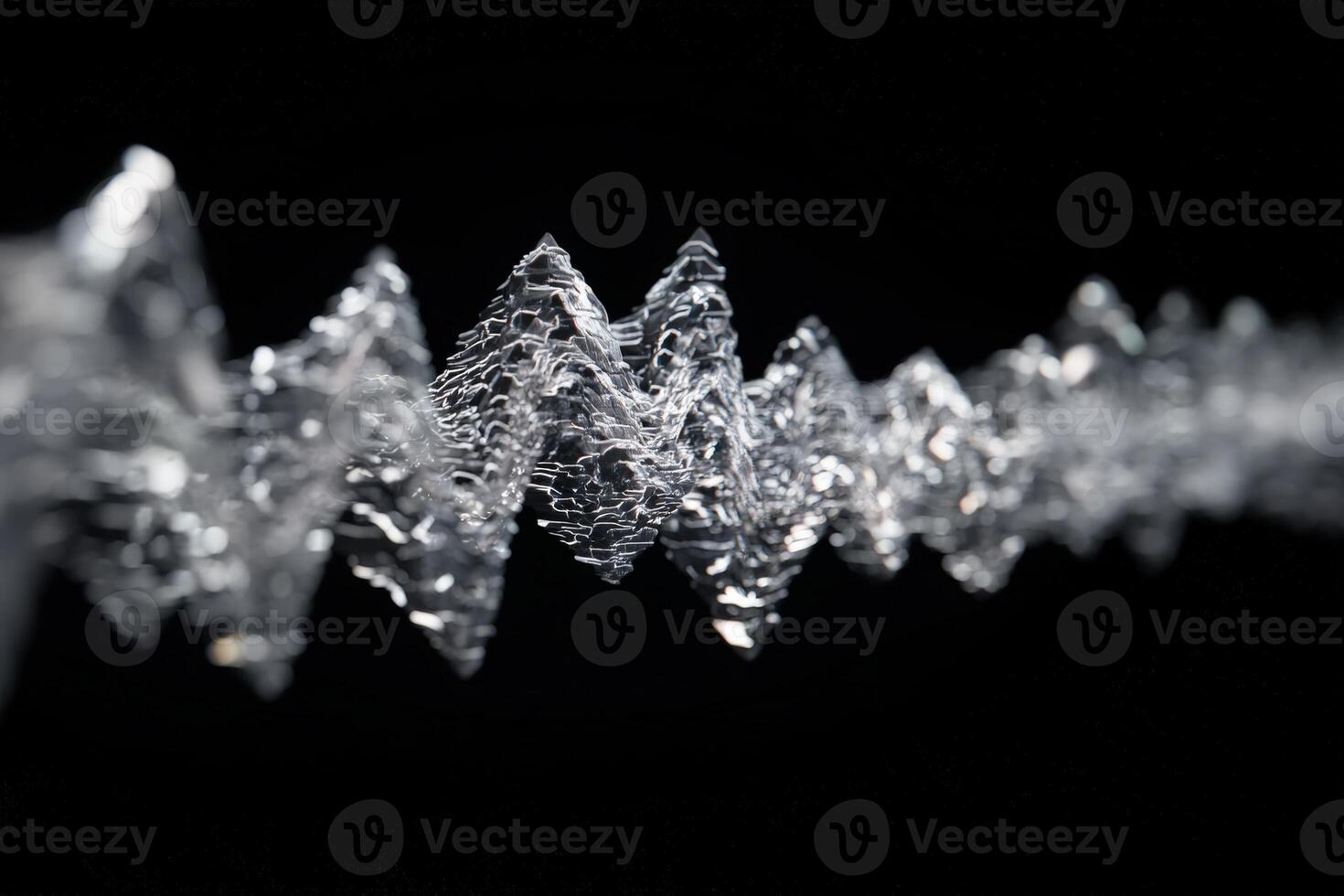 Abstract close-up of a twisting, crystalline wave-like structure in focus against a blurred backdrop, featuring sharp, jagged peaks and delicate patterns, creating a dynamic visual effect photo