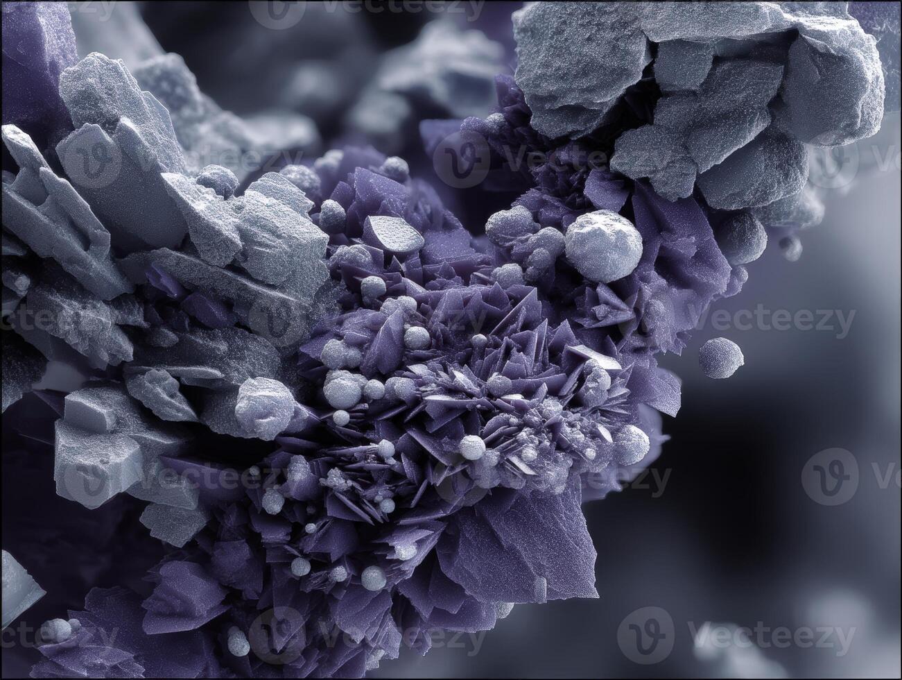 Intricate purple and gray crystalline structures with various geometric shapes and textures. Some areas appear rough and jagged, while others exhibit smooth surfaces and round formations photo