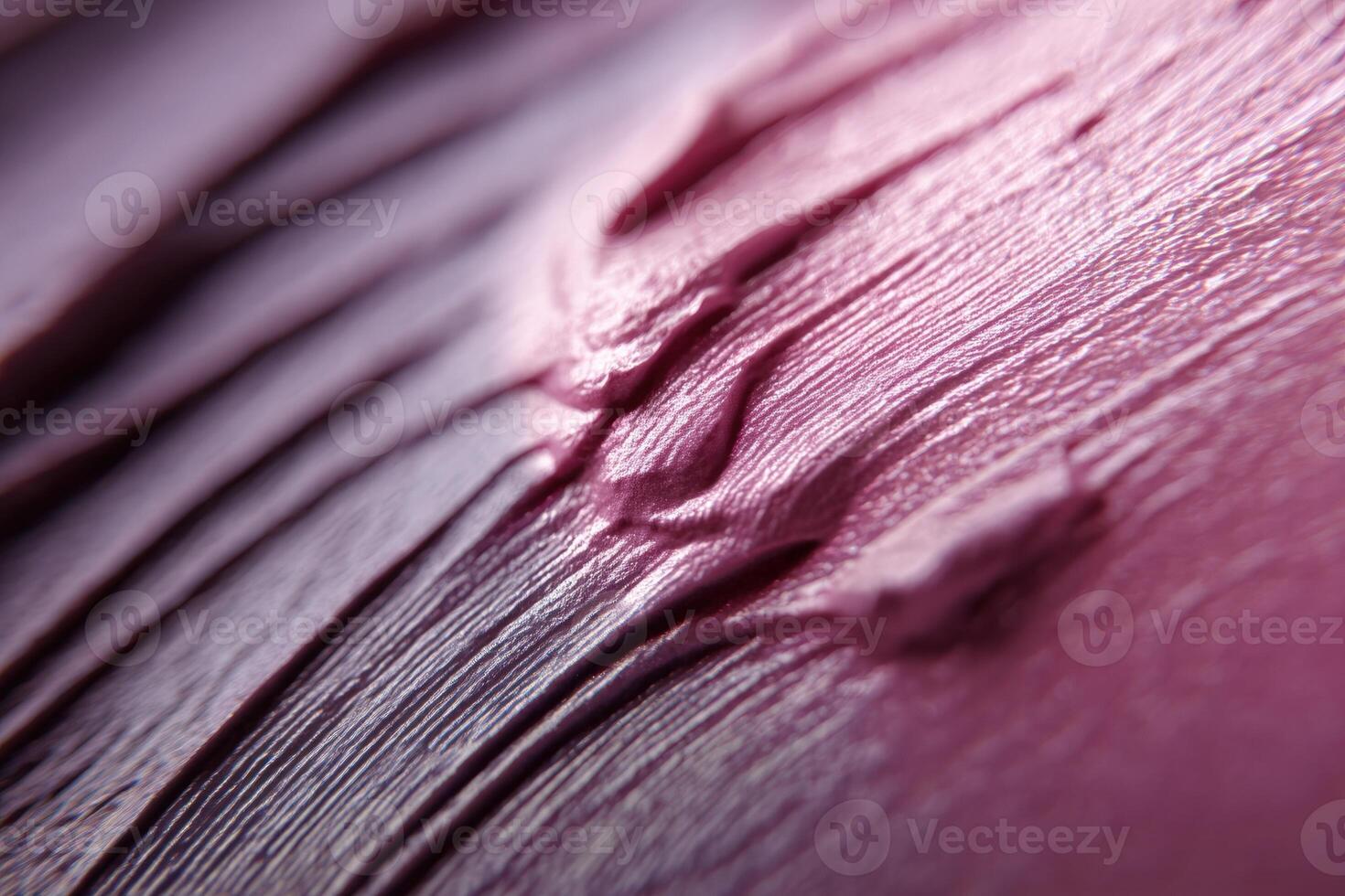 Pink textured surface featuring smooth, wavy patterns with varying shades. The close-up provides an abstract feel, highlighting the rich brush strokes and glossy finish photo