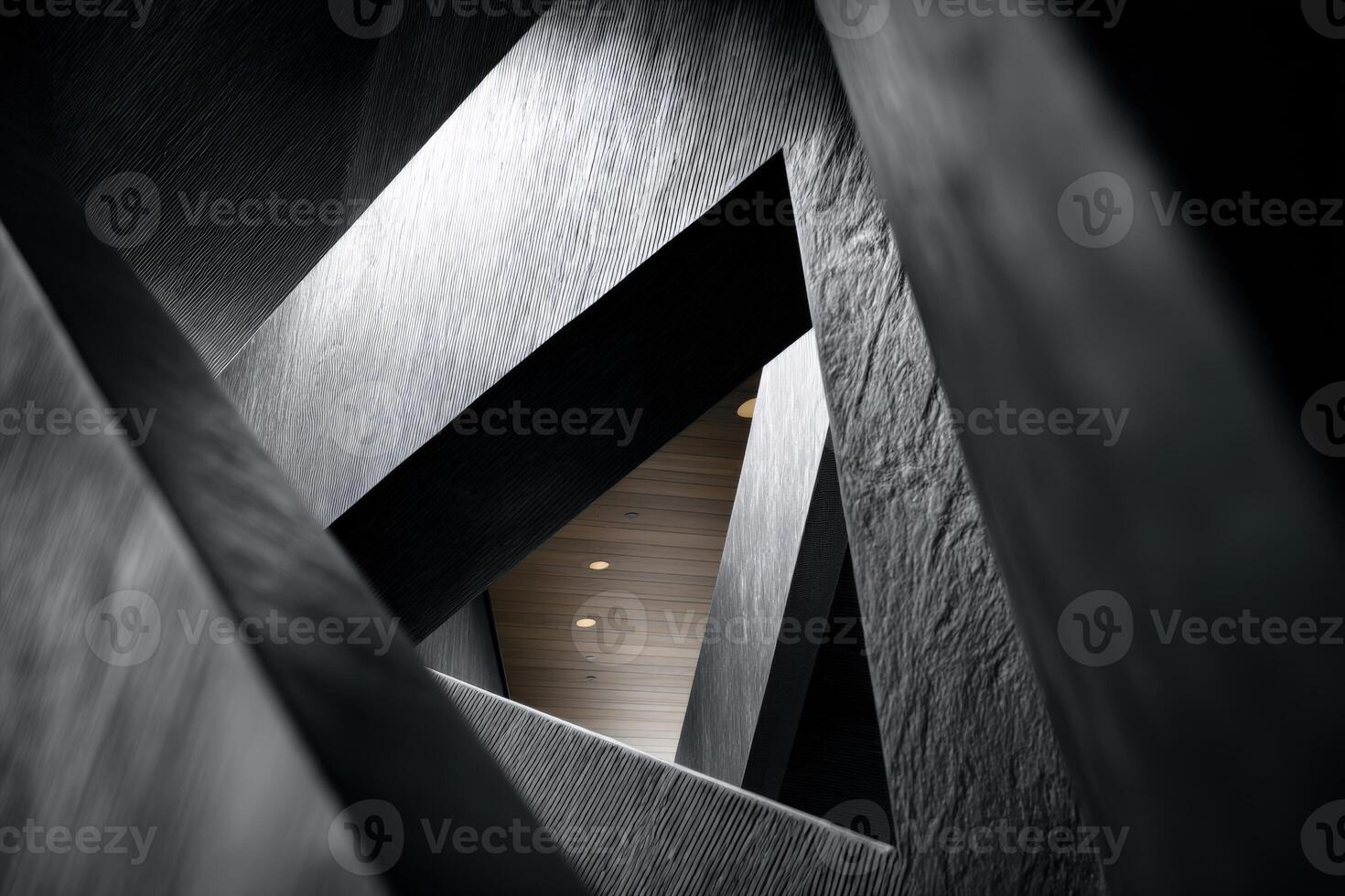 Angular architectural design featuring intersecting gray and black geometric structures creating dynamic triangular shapes with shadows and light accents photo