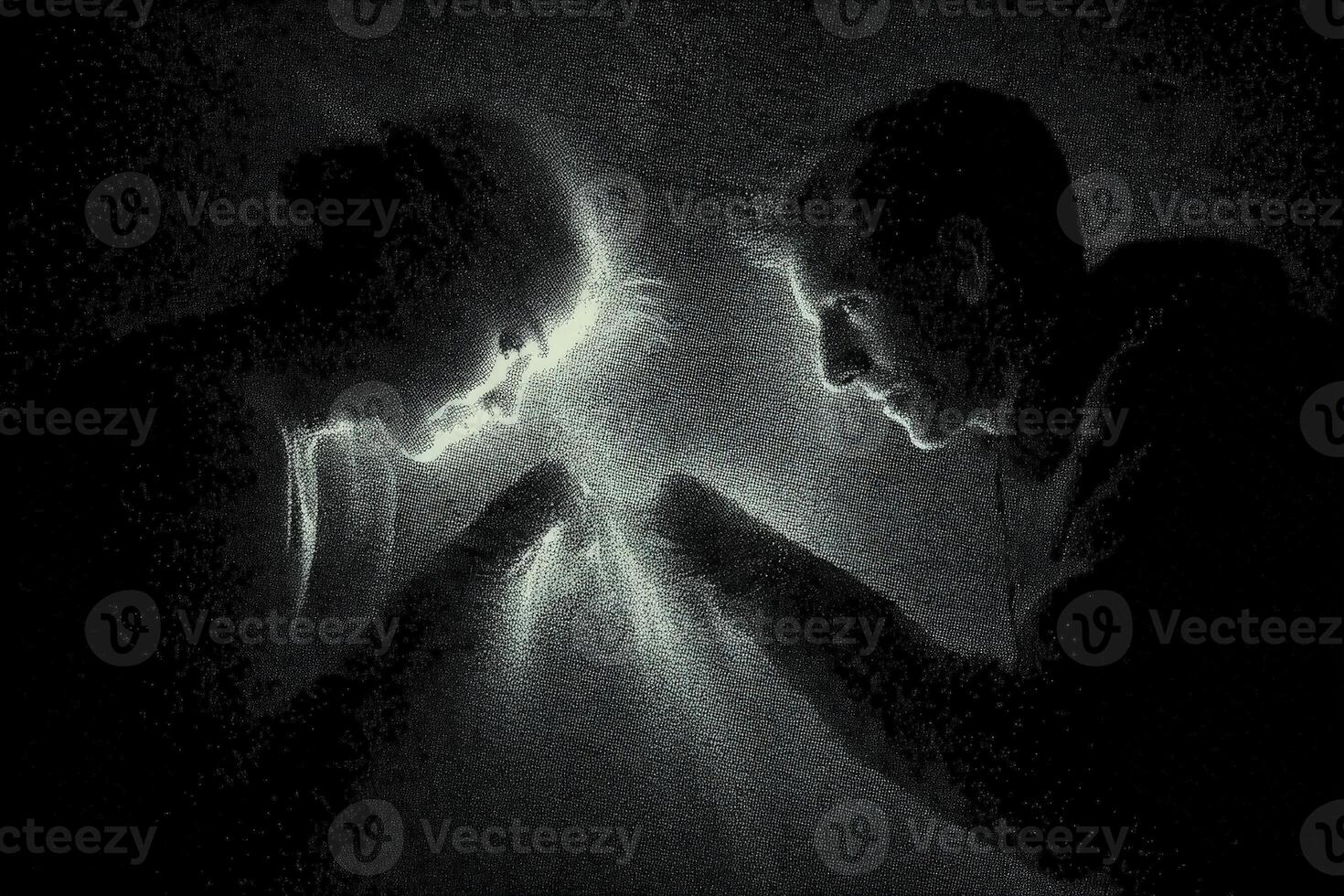 Silhouetted figures face each other with hands close a glowing light emanates between their palms, casting an ethereal glow on their faces and creating a mysterious, intimate atmosphere photo