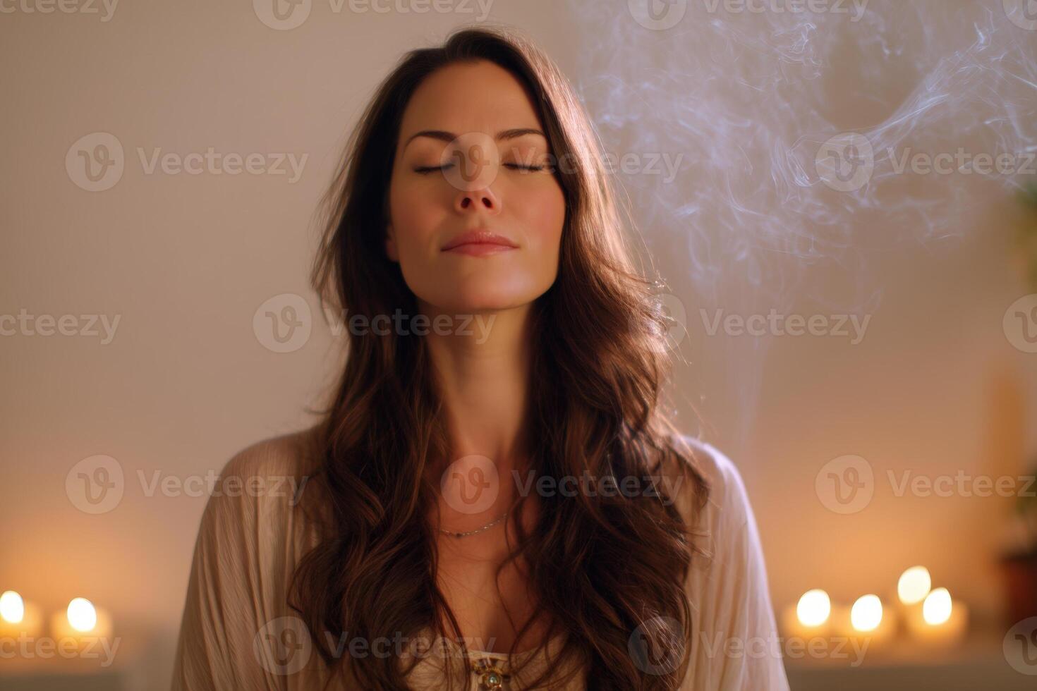 Peaceful woman with long hair meditates with eyes closed, surrounded by soft candlelight and gentle smoke swirls, creating a serene and contemplative atmosphere photo