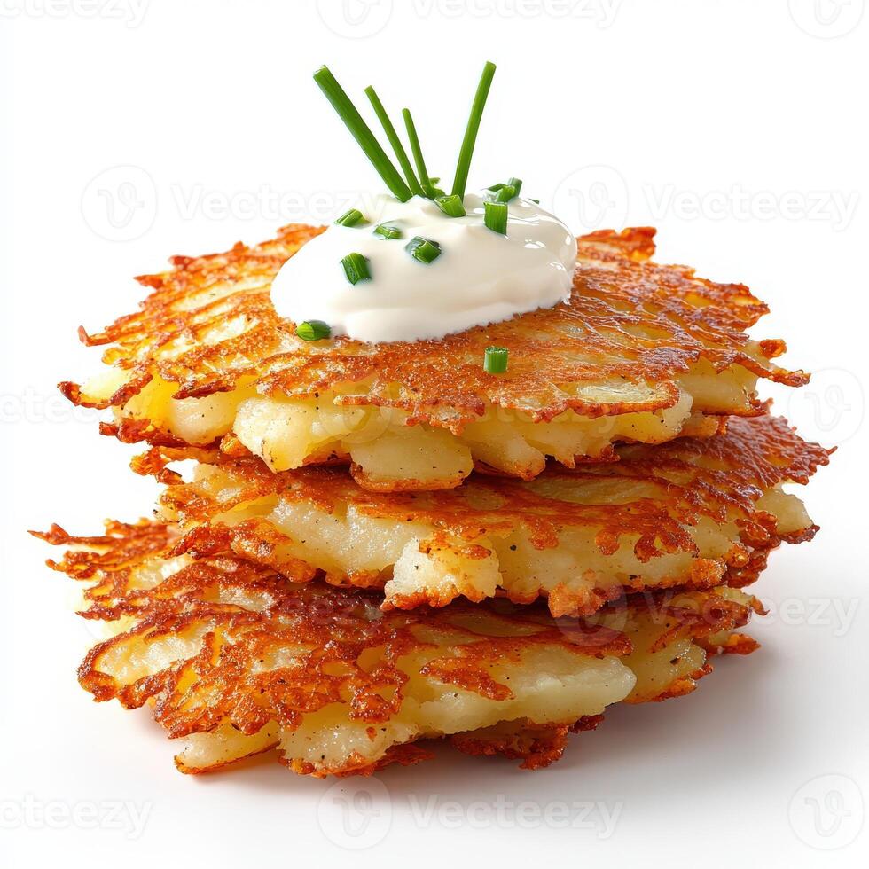 A stack of potato pancakes with sour cream photo