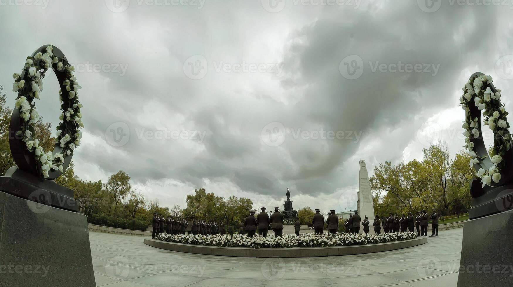 A 360 - view of a memorial with flowers and a statue photo