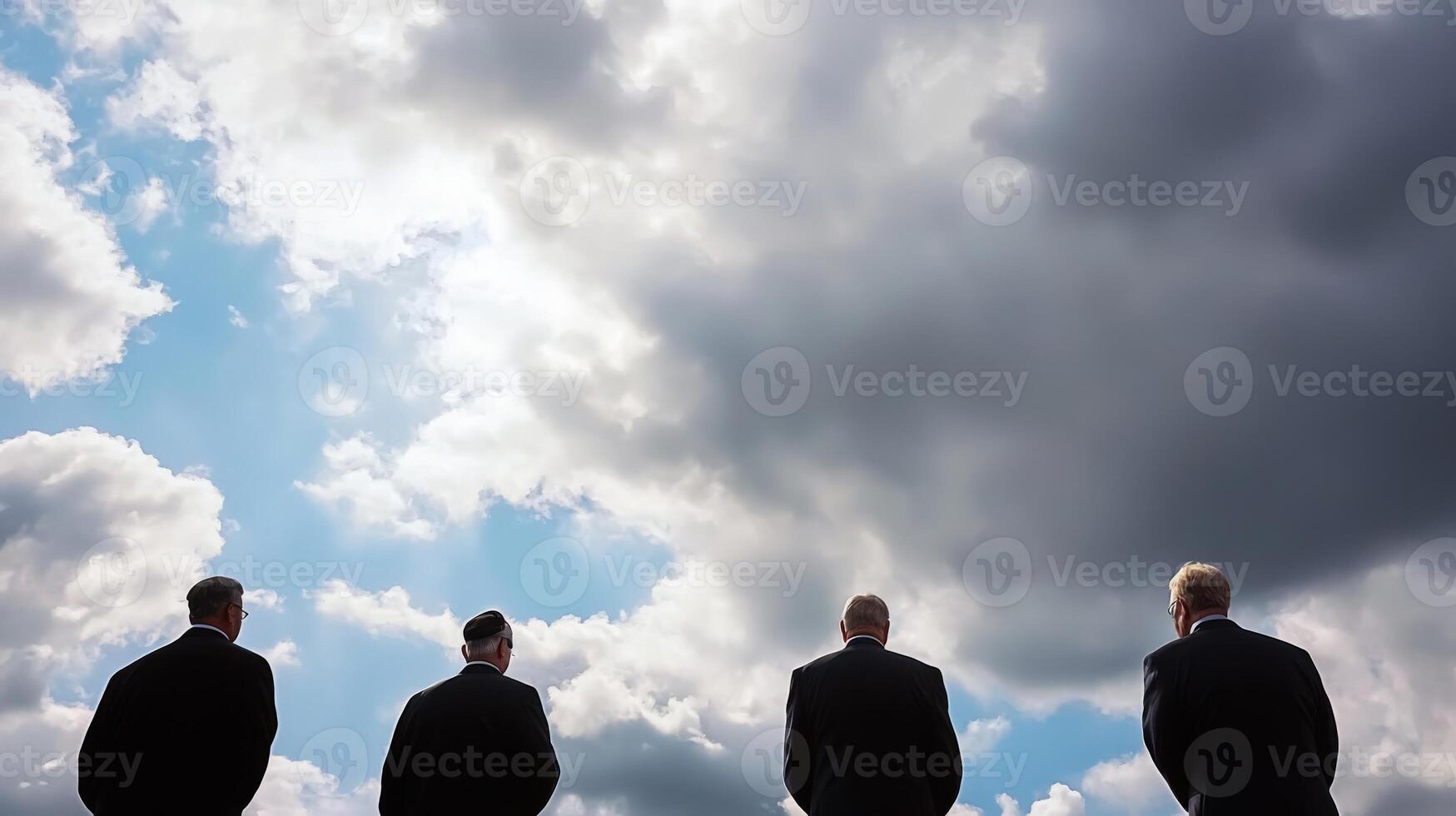 Three business people standing in front of a cloudy sky photo