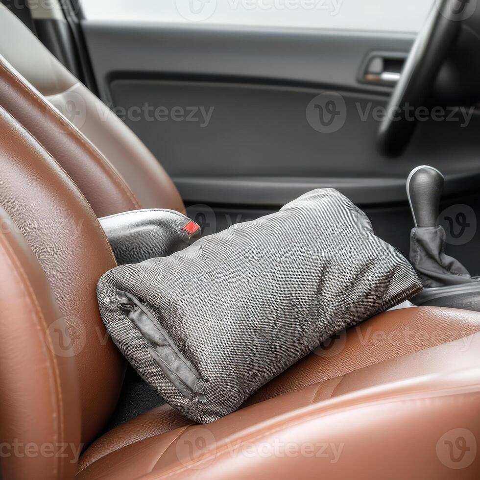 A gray pillow on the seat of a car photo
