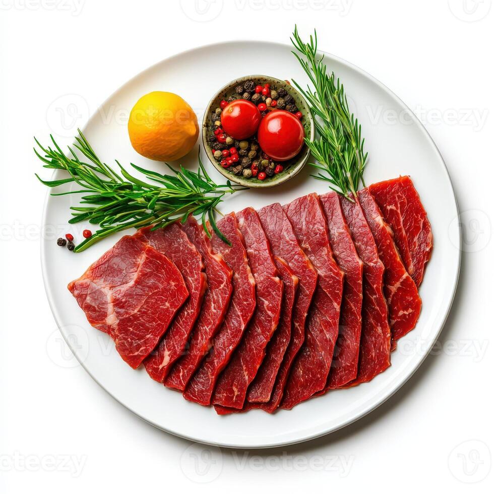 Sliced beef on a white plate with rosemary and lemon photo