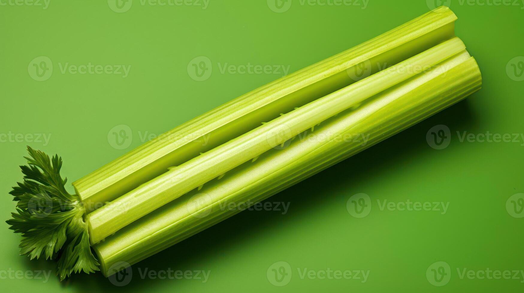 Close-up of a fresh celery stalk against a green background. photo