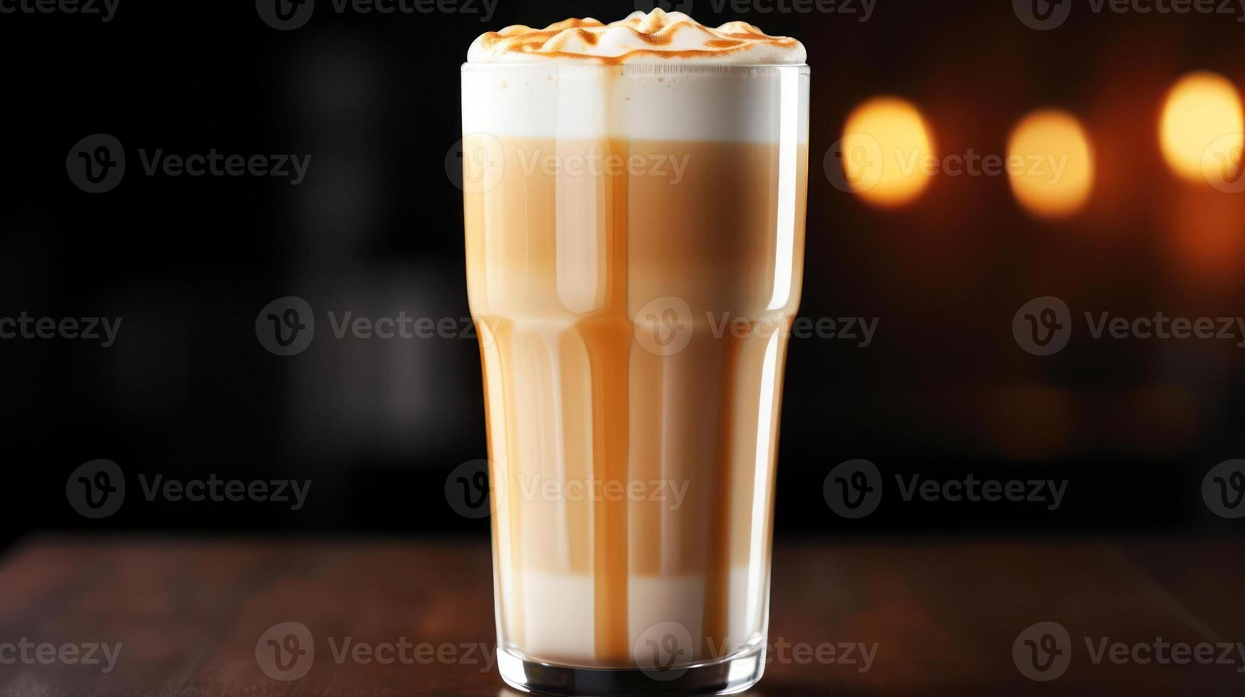 Caramel latte in a glass, warm lighting. photo
