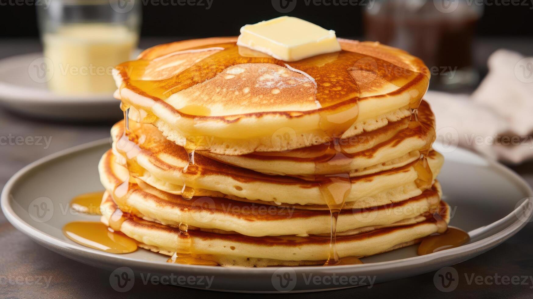 Stack of pancakes with butter and syrup on top photo