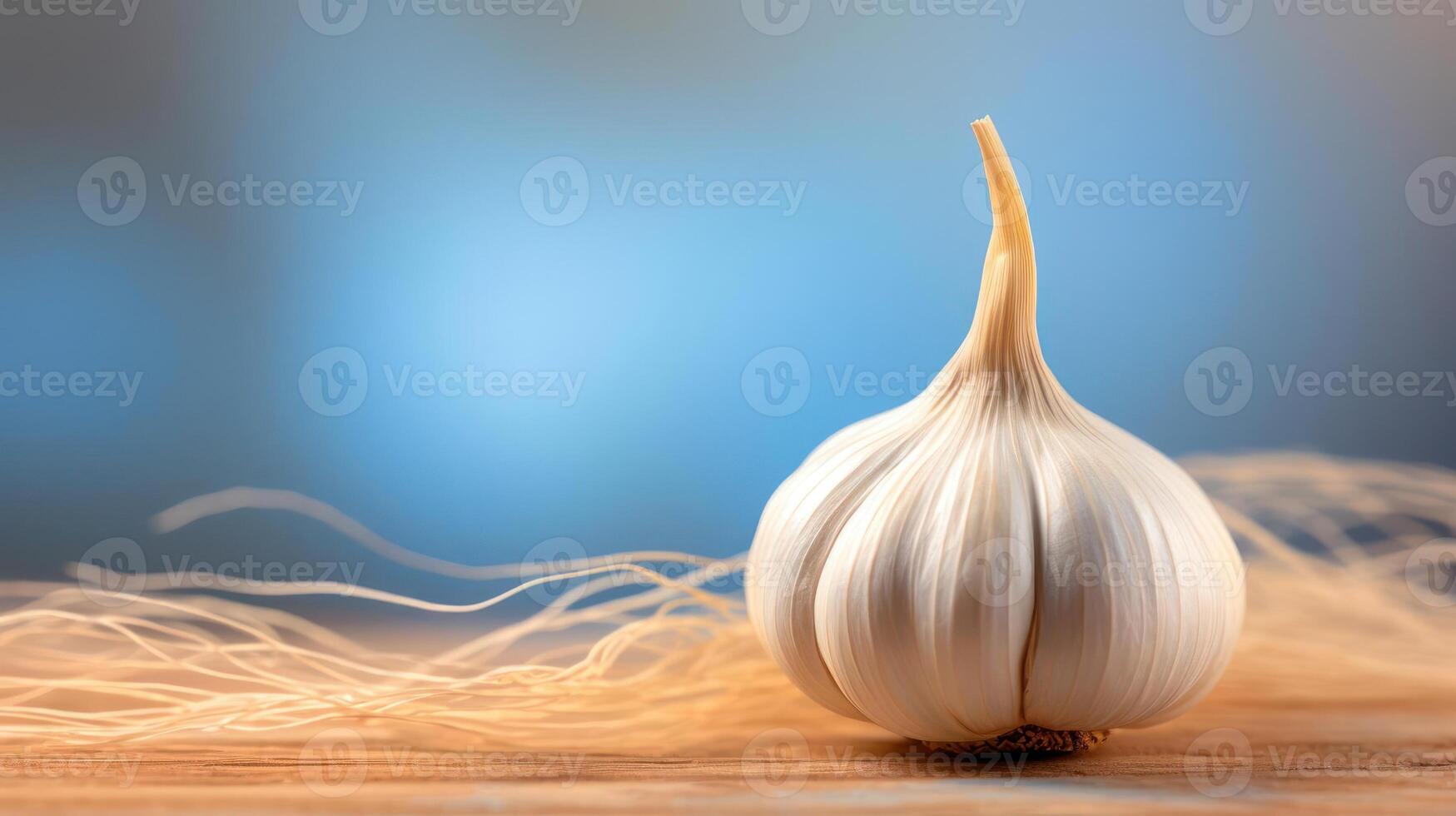 Garlic on wooden table with blue background photo