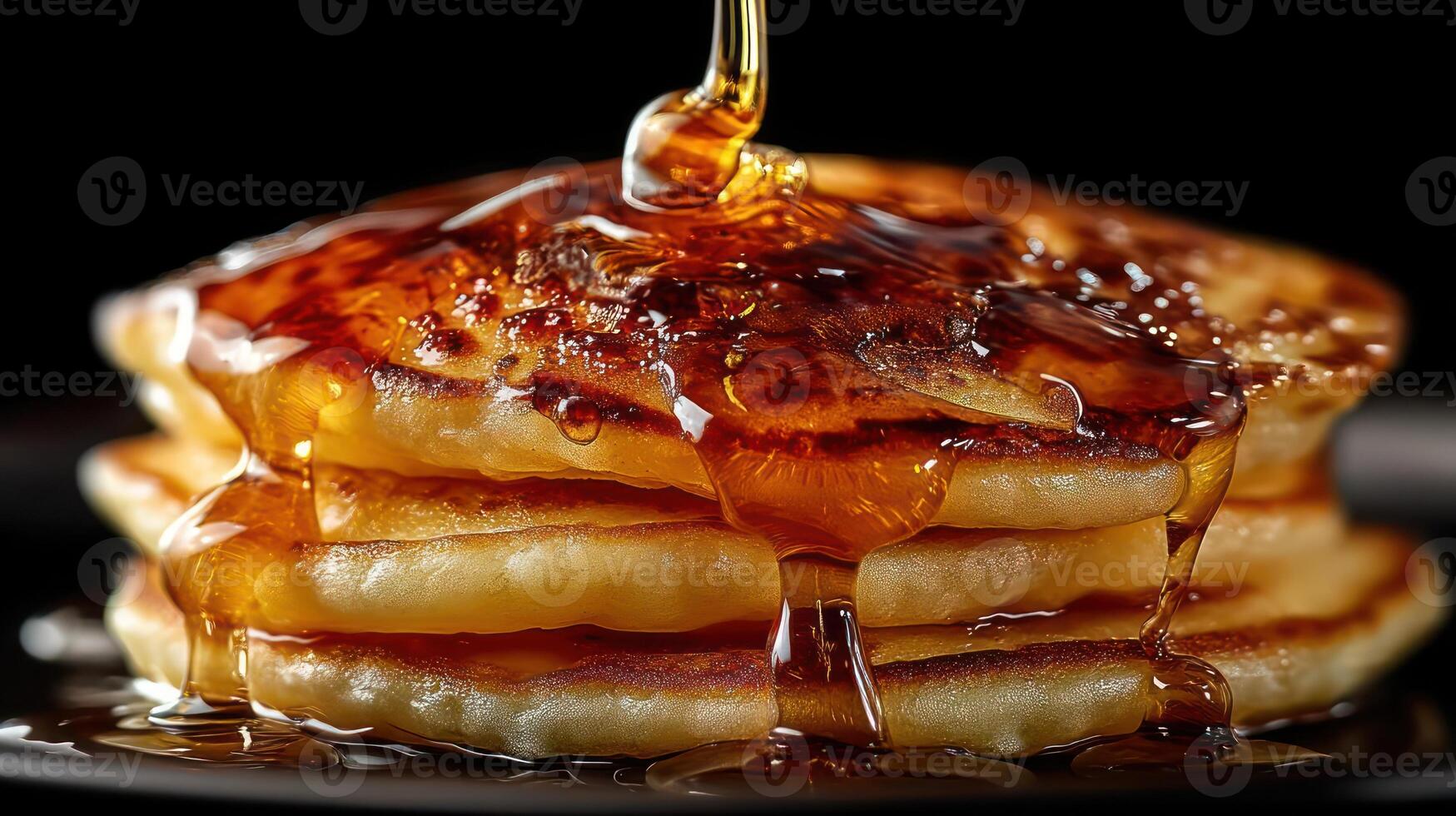 Stack of pancakes drizzled with golden syrup. photo