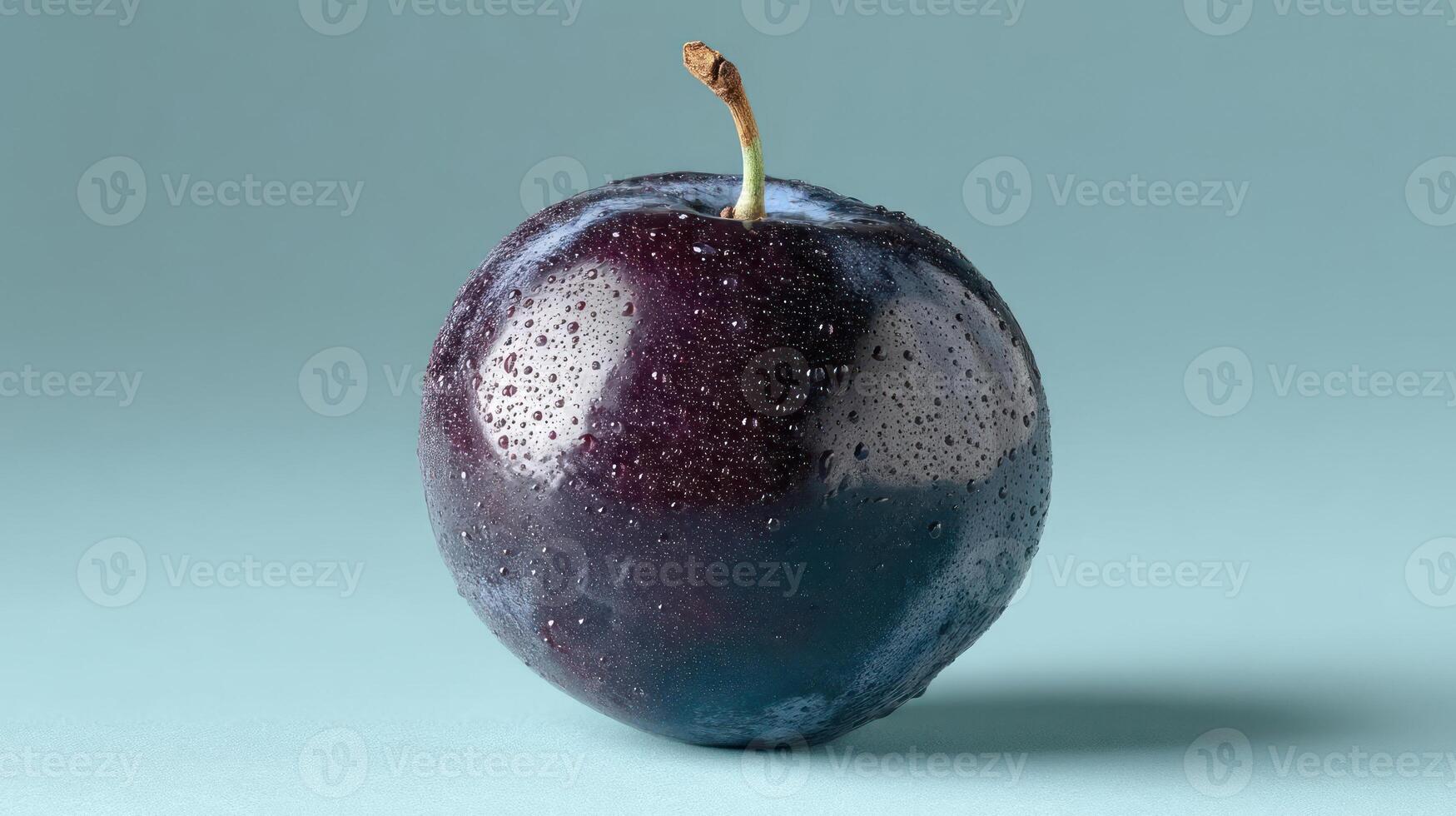 A juicy, ripe plum with water droplets on a blue background. photo