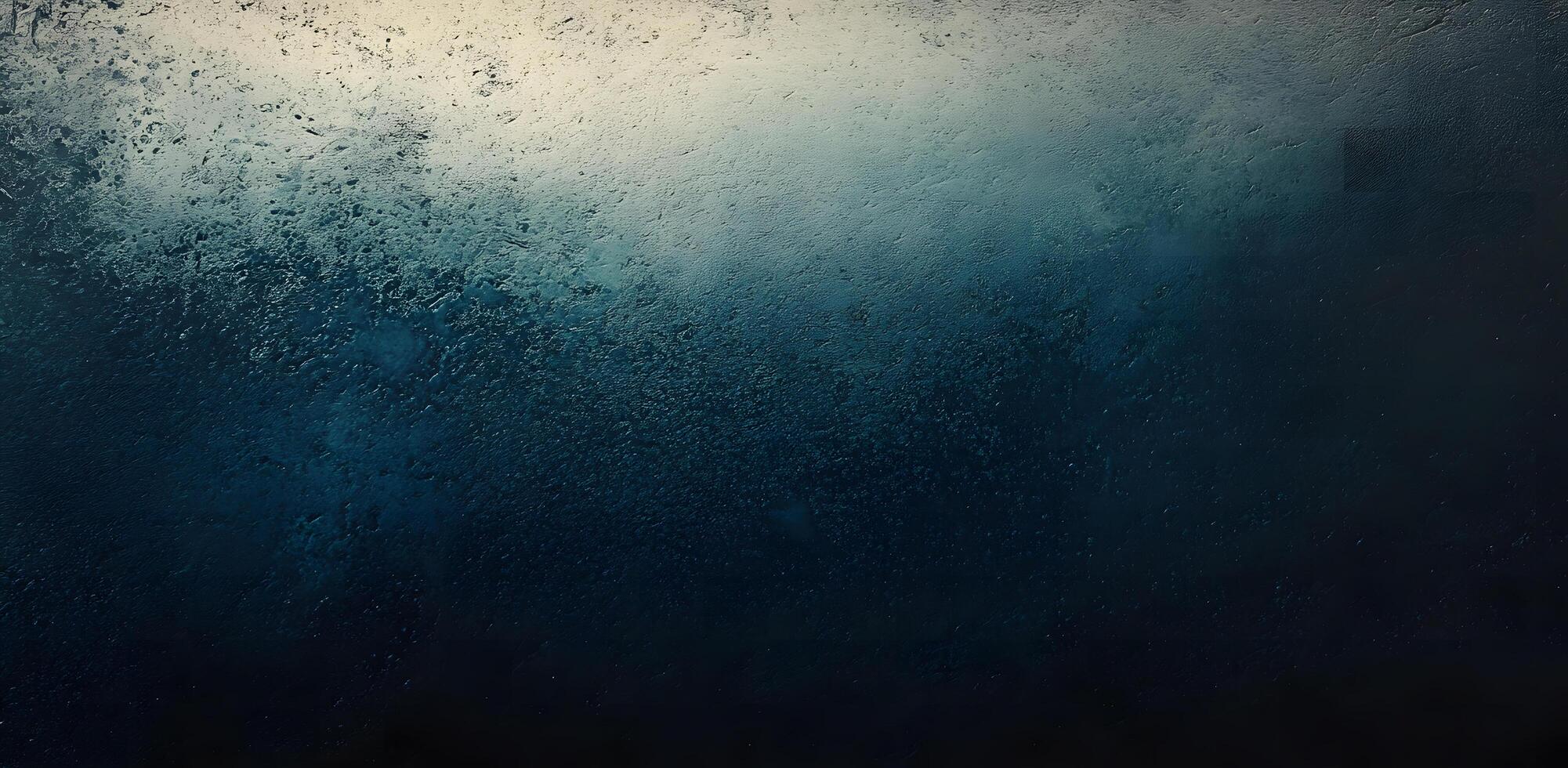 Abstract dark blue grunge texture creates an ombre effect towards the light, neutral surface photo