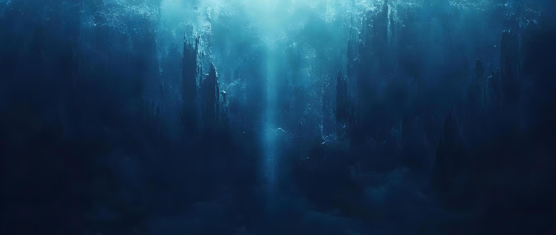 An ethereal light descends through the depths, casting blue shadows in an underwater landscape photo