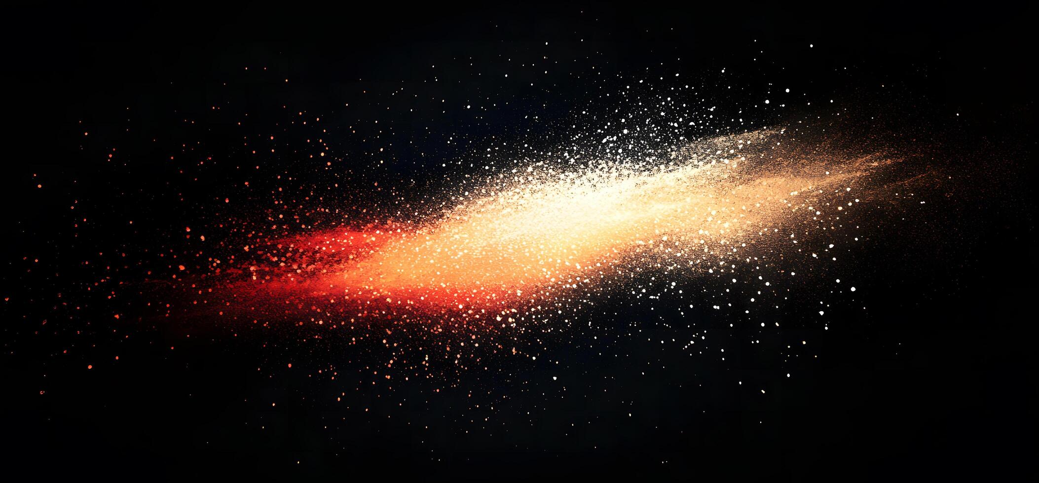 An explosion of red and gold colored powder particles traverses a dark canvas photo