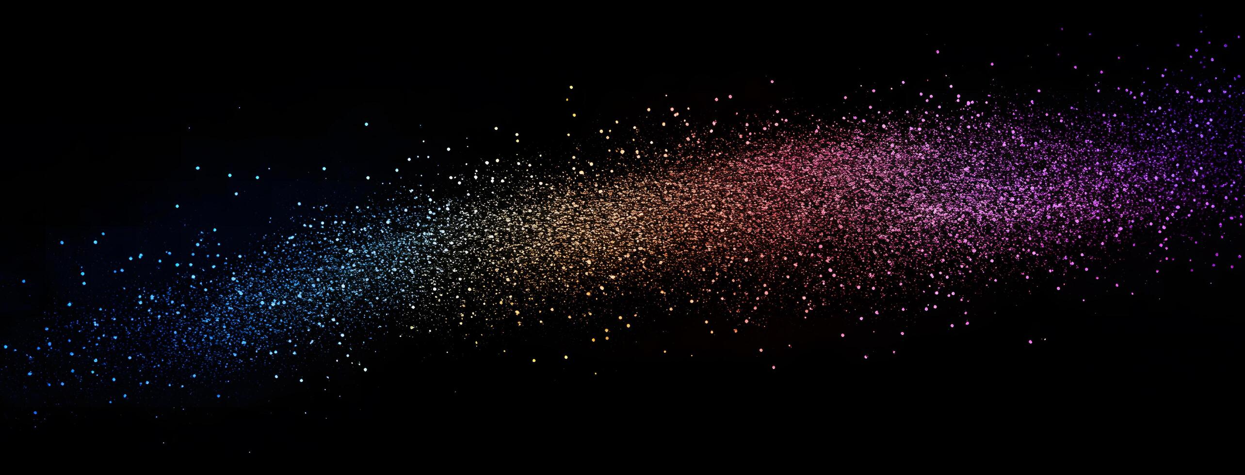 Rainbow glitter particles diagonally spread across a black background create a magical and colorful effect photo