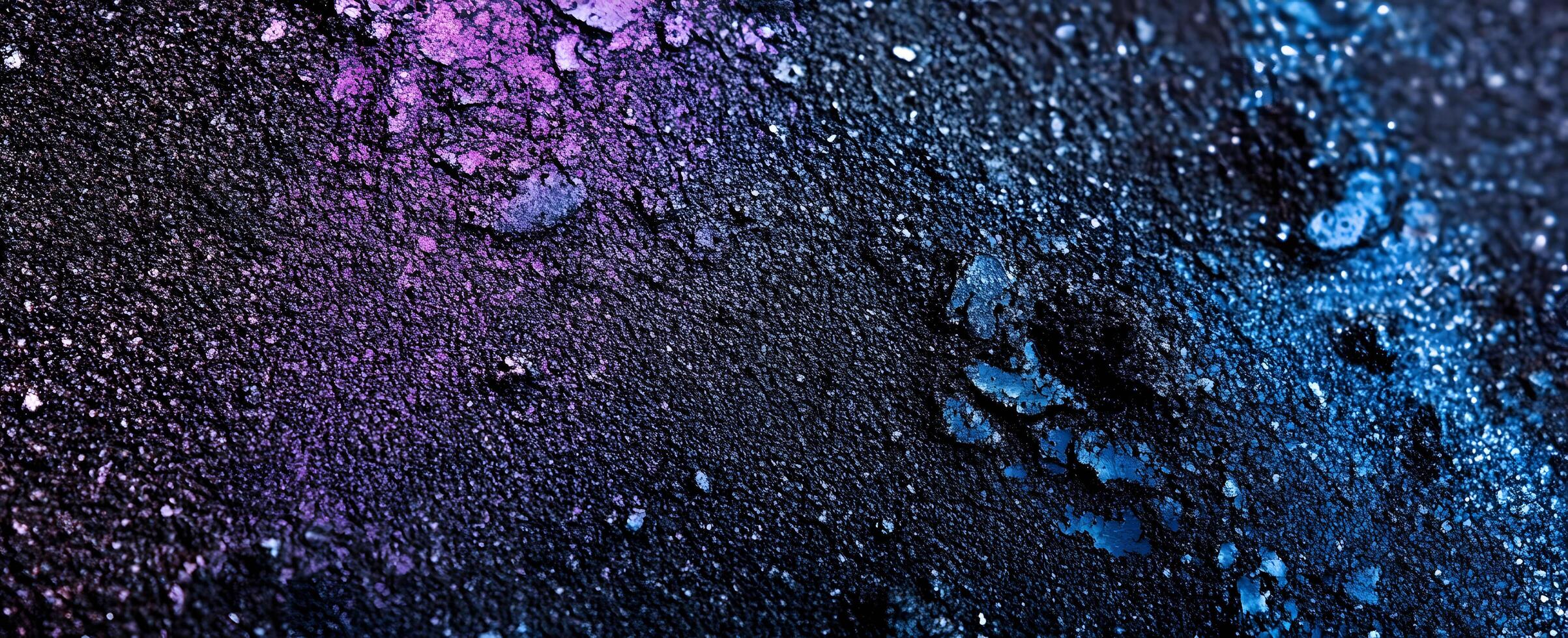 Rough textured material reveals a blend of dark purple and blue mineral patterns across the surface photo