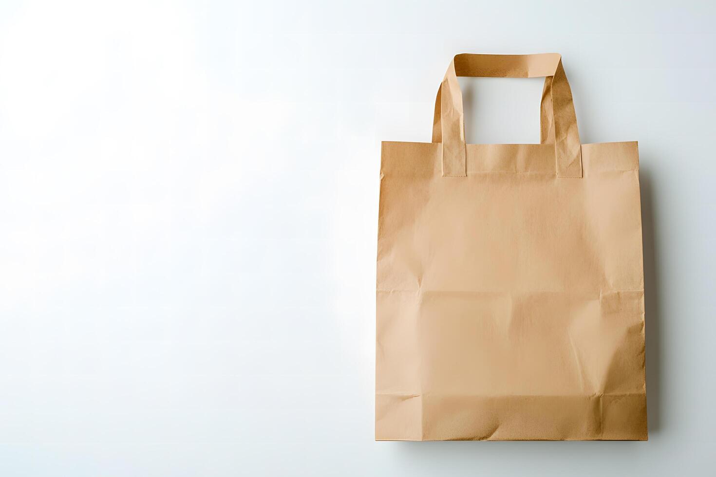 Simple brown paper bag stands against a clean white background, awaiting reuse photo