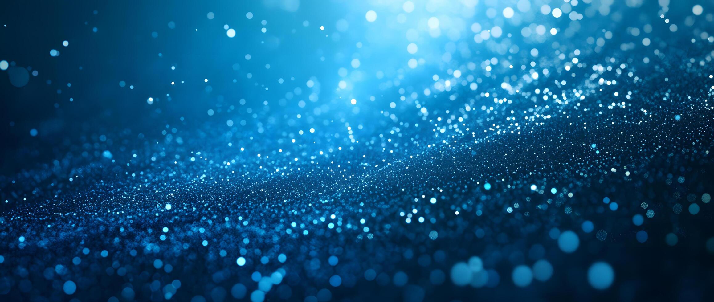 Sparkling blue glitter scatters and shines, creating a magical, ethereal effect in the darkness photo