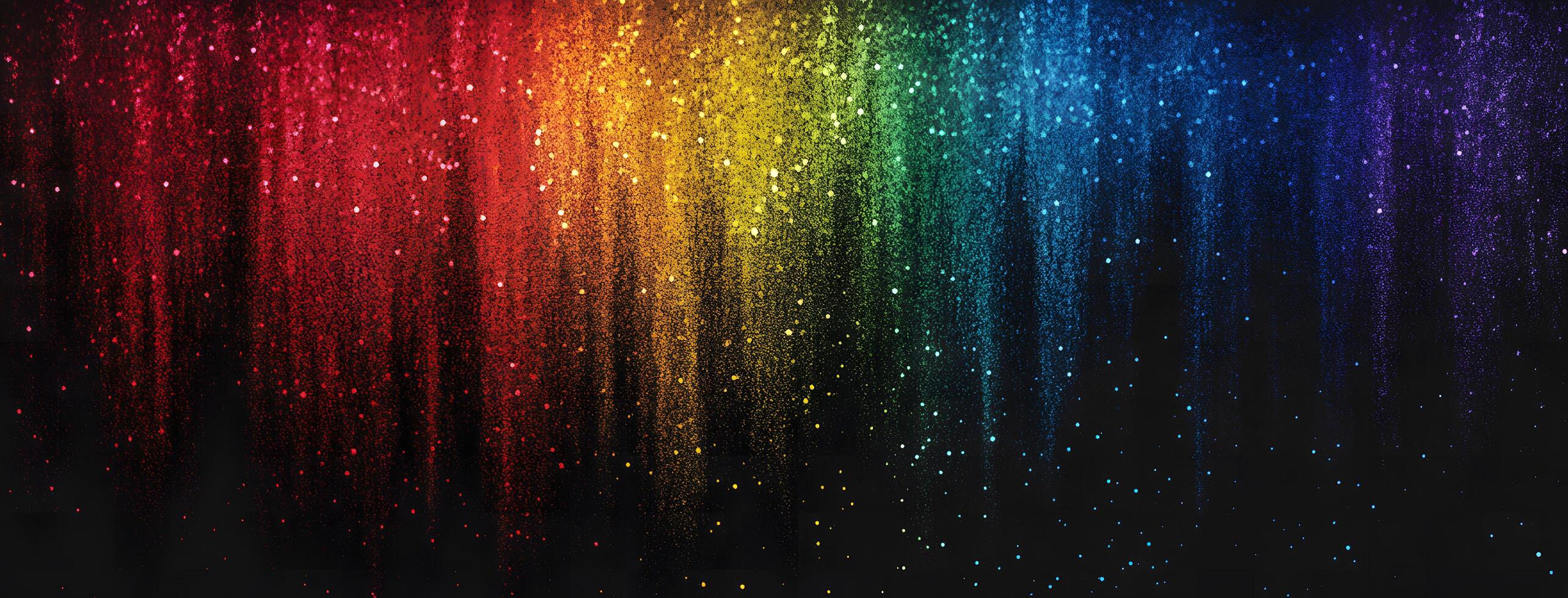 Sparkling rainbow colors cascade down creating a vibrant and colorful gradient on a black background photo