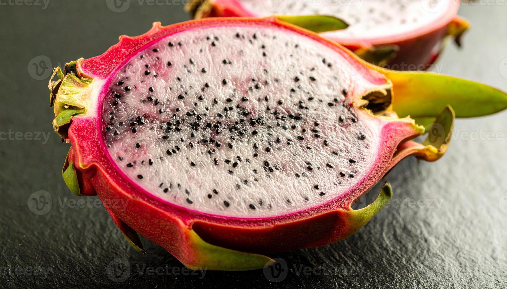 A dragon fruit is cut in half photo