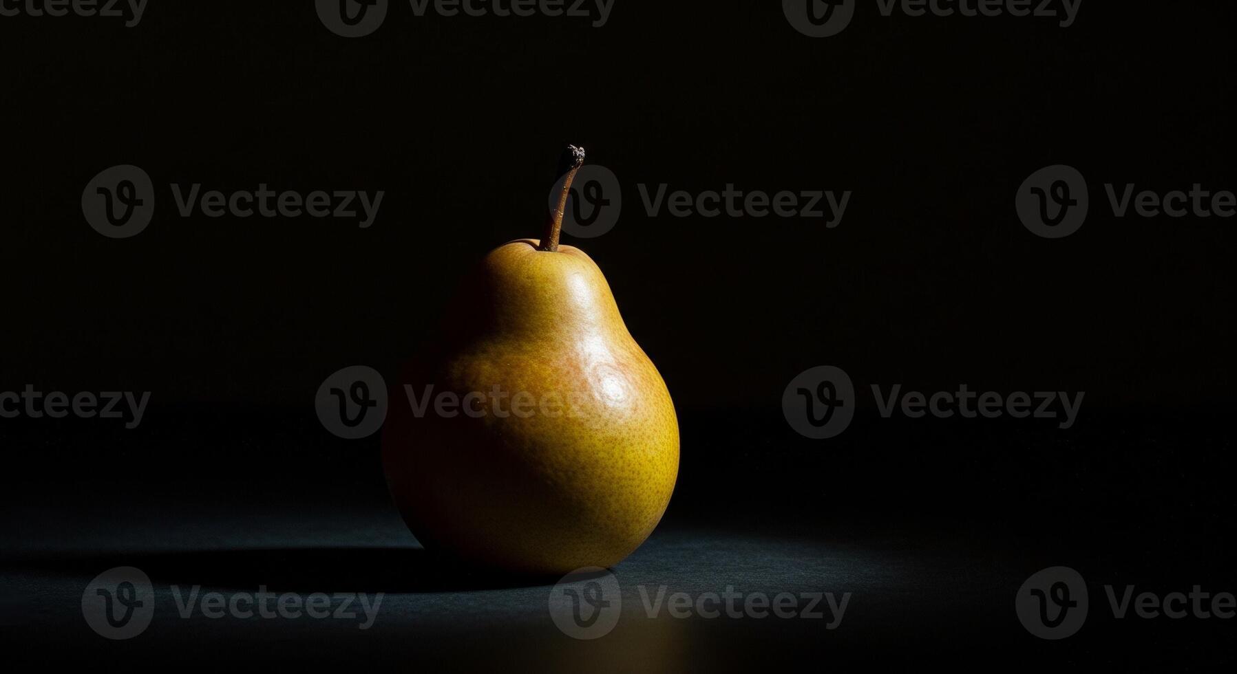 A single pear on a dark surface photo