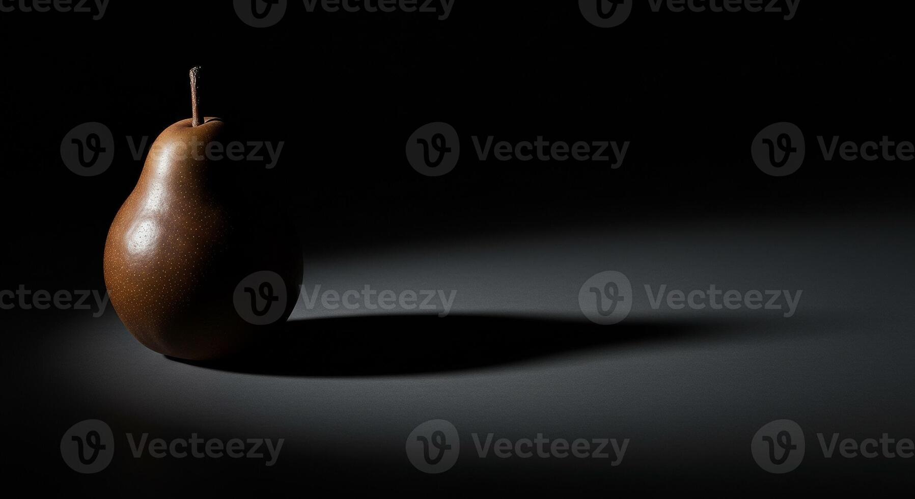 A pear is shown in the dark with a shadow photo