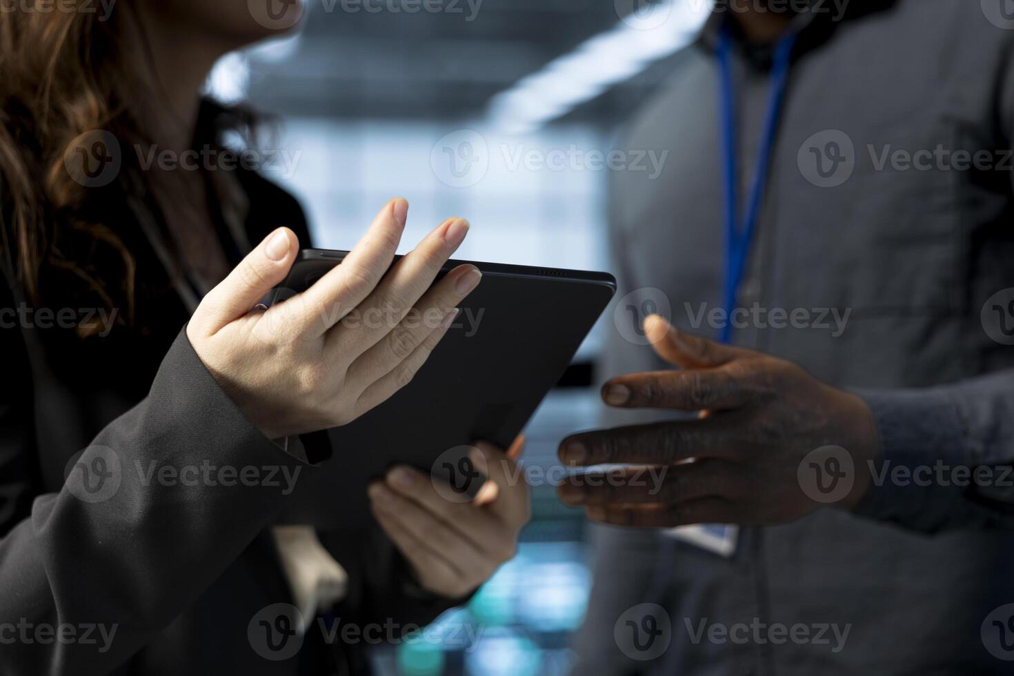 Teamworking data center admins using laptop, conducting security audits, preventing vulnerabilities. Close up of IT staff members using device to review firewall rules, logging incident details photo