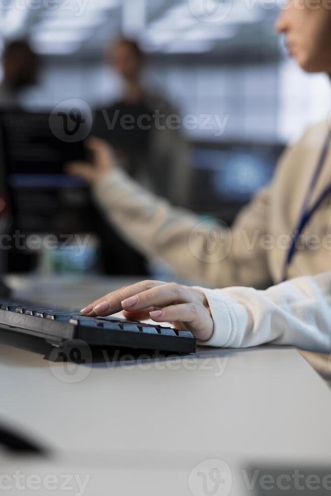 Technician in server room typing on keyboard, implementing power management solutions to reduce energy consumption. Close up of IT specialist integrating new technologies and systems in data center photo