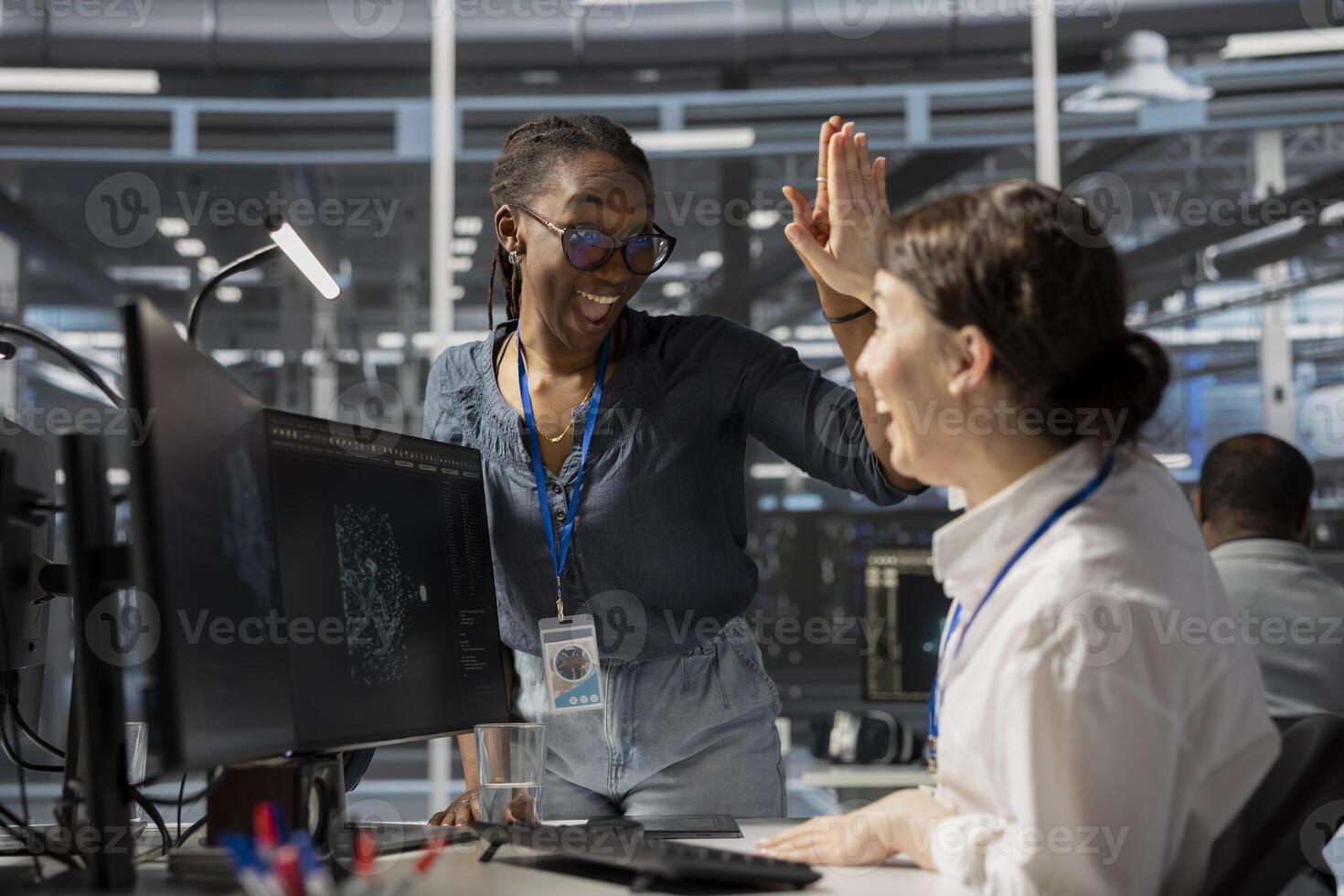 Supervisor praising data center worker accomplishments after improving system efficiency. Pleased server farm manager does high five with technician pleased after enhancing infrastructure with update photo