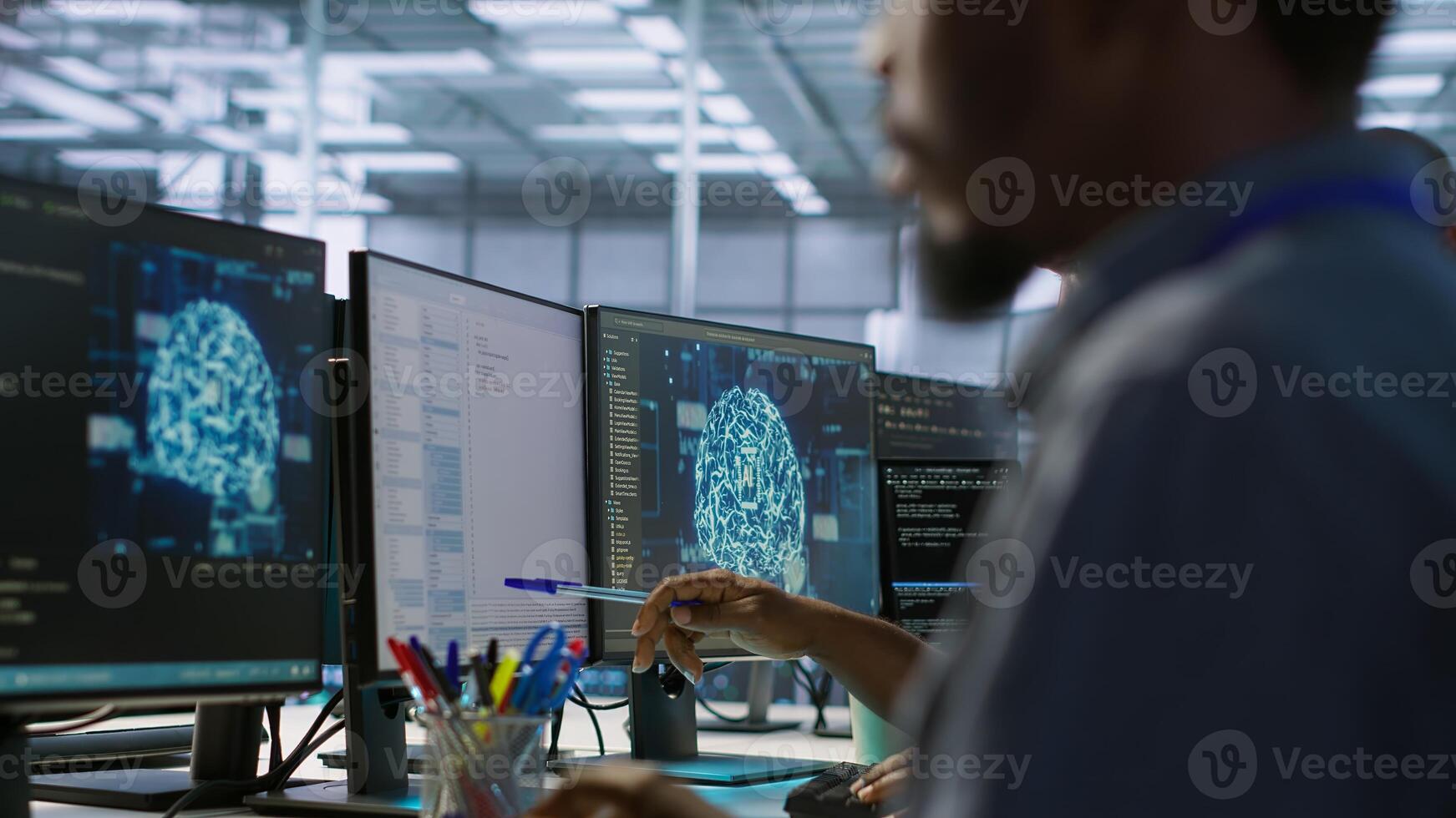 Machine learning expert in data center maintaining company network infrastructure. Worker using artificial intelligence server hub to ensure optimal system performance, camera A photo
