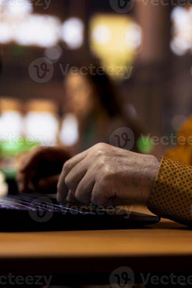 Elderly adult reading complex research documents under a green lamp, showcasing the power of wisdom and focus in senior learning environments. Academic studying in a public library. Close up. photo