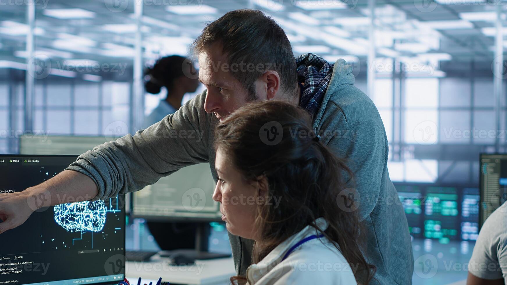 IT team members programming scripts on computer, employing AI machine learning. Software developer and coworker manipulating lines of code for artificial intelligence applications, camera A photo