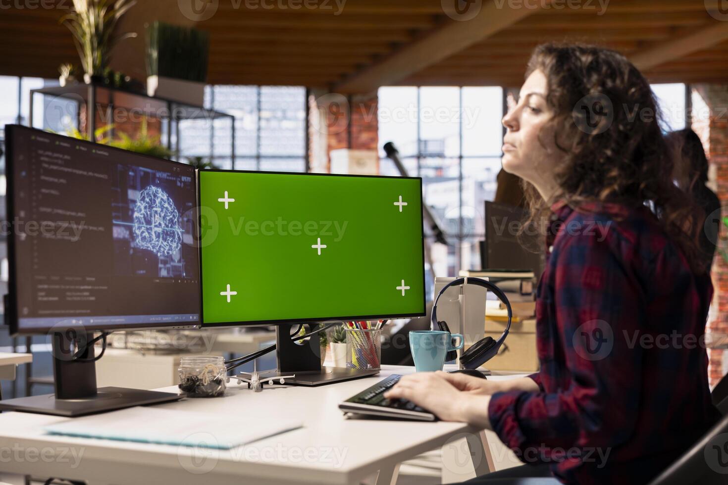 Software developer using green screen computer to do maintenance on artificial intelligence neural networks. IT specialist in tech startup office using AI machine learning systems on chroma key PC photo