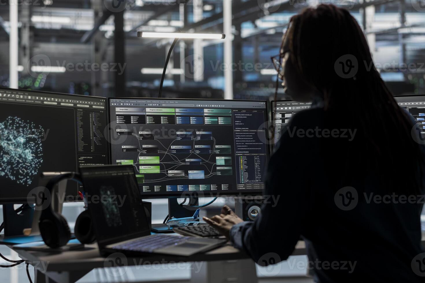 Data center software developer looks at AI visualization dashboard to pinpoint equipment performance issues. Server farm expert looks at node tree and data analysis graph on computer photo