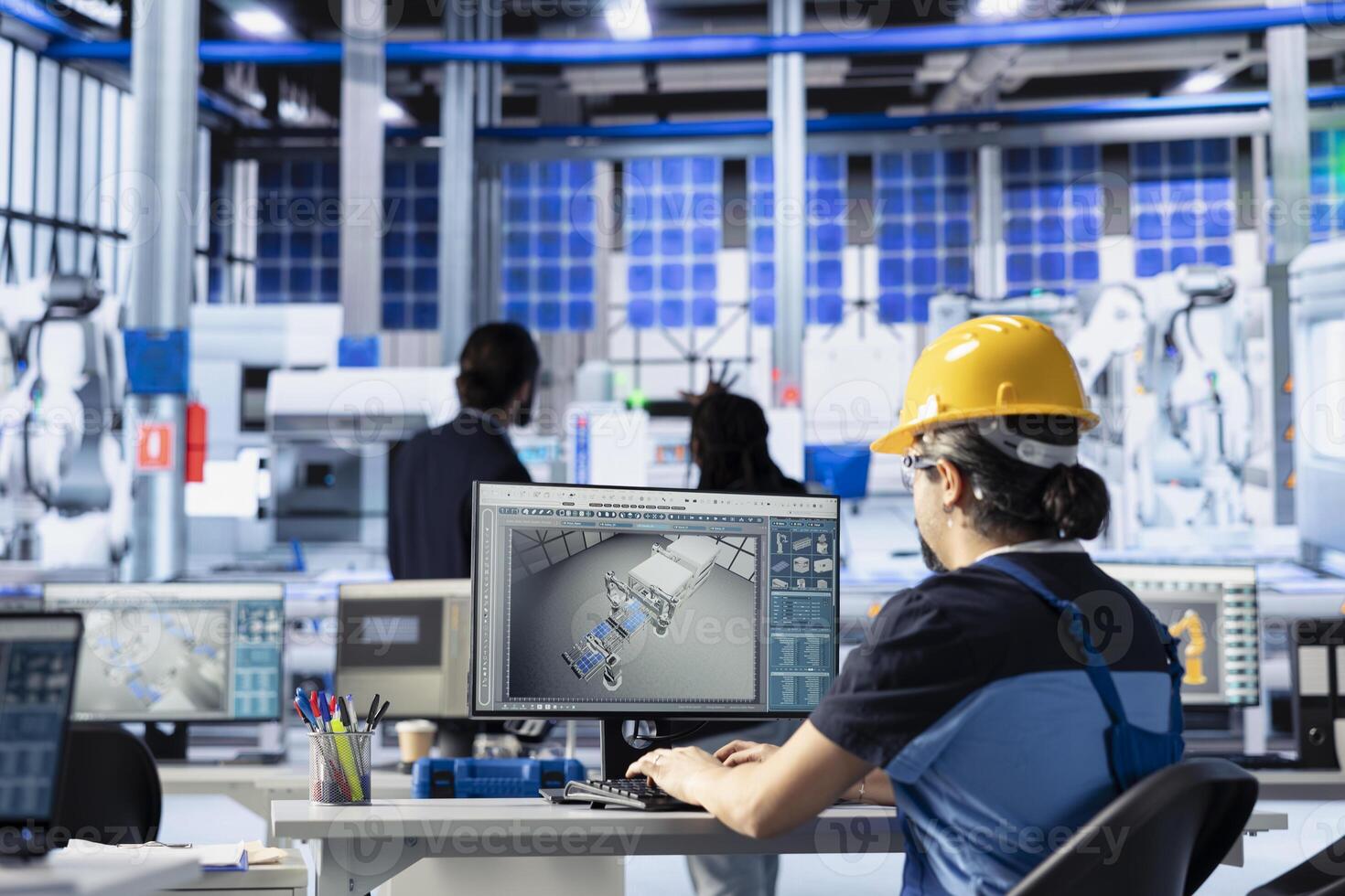 Green energy photovoltaics factory engineer adjusting system parameters on PC to maximize power generation. Technician optimizing energy supply in eco friendly solar panel manufacturing plant photo